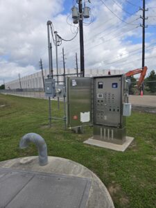 Installed lift station control panel and pump discharge piping