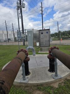 Stormwater Professionals Group lift station control panel installed on site with discharge piping